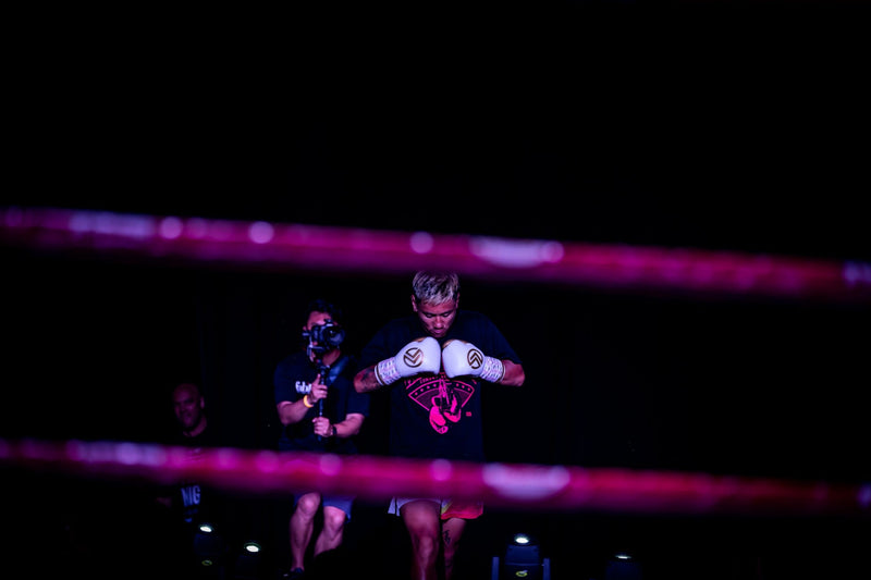 Red Line Combat Academy fighter preparing for a bout under ring lights